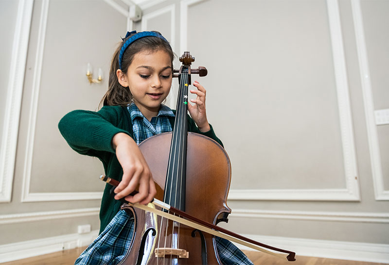 Pupil playing a cello